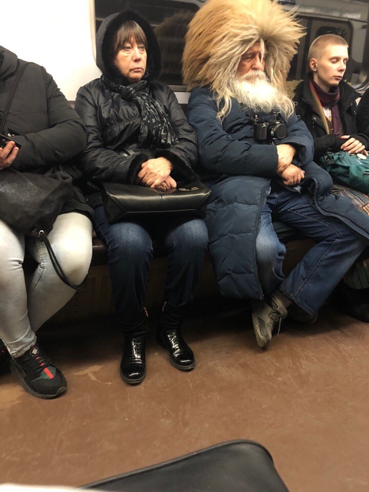 A man with fur hat in metro