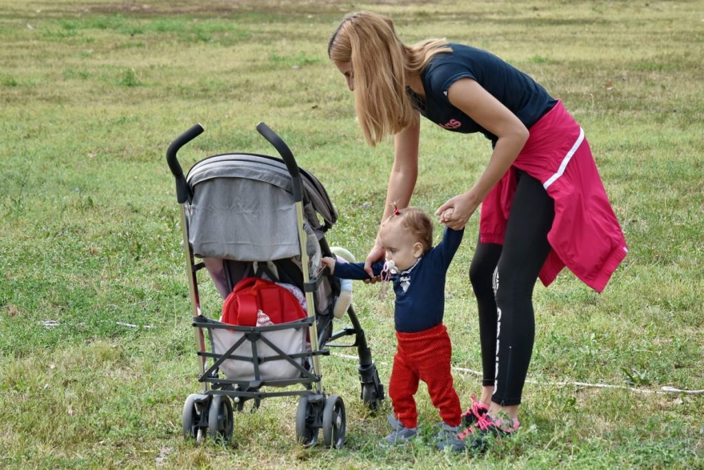 Mother and child with pram in a park